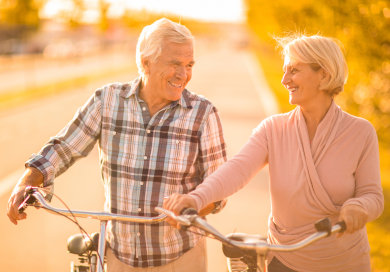 Couple walking down road with bikes